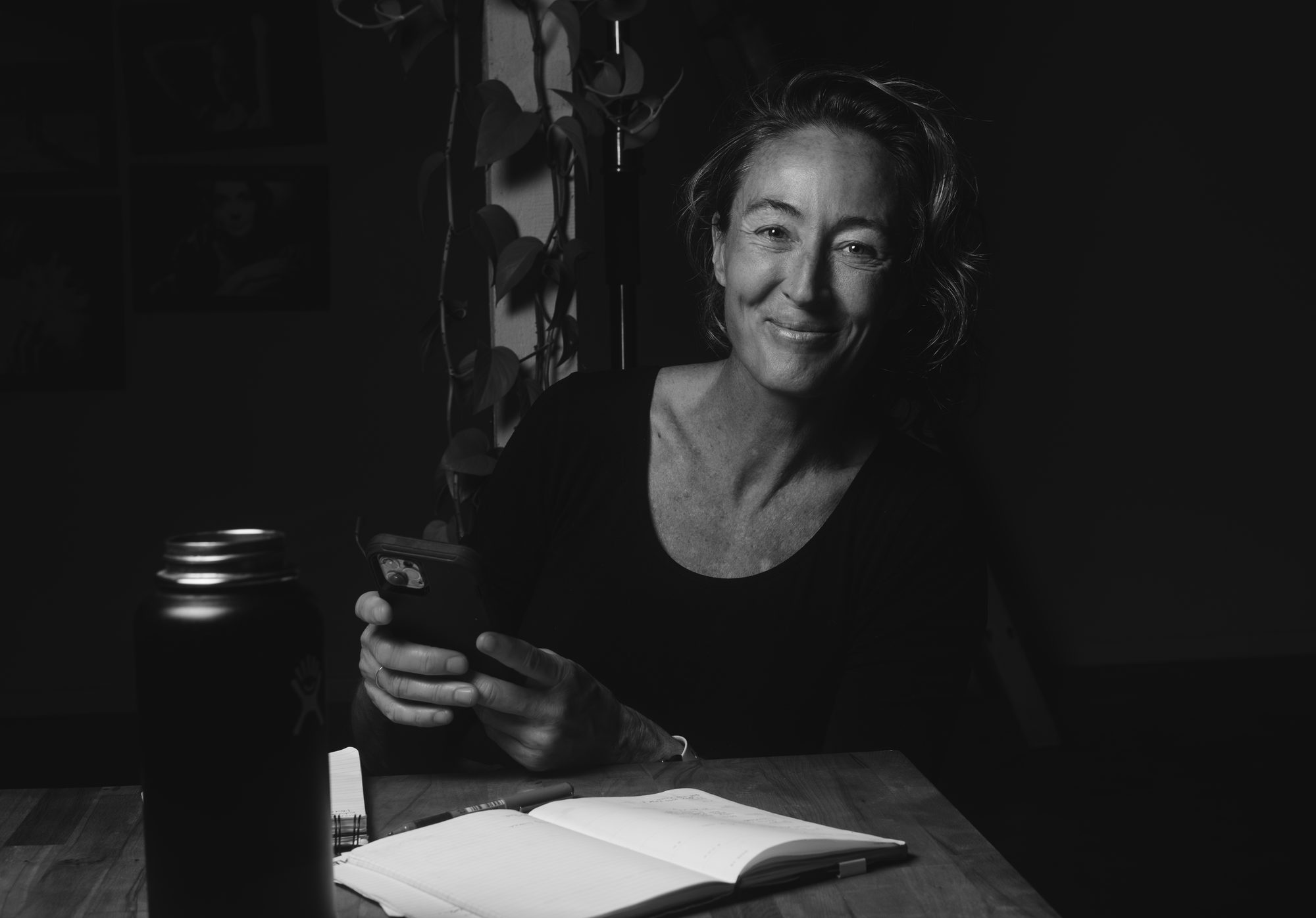 Loralee smiling at her desk with a notebook open in front of her